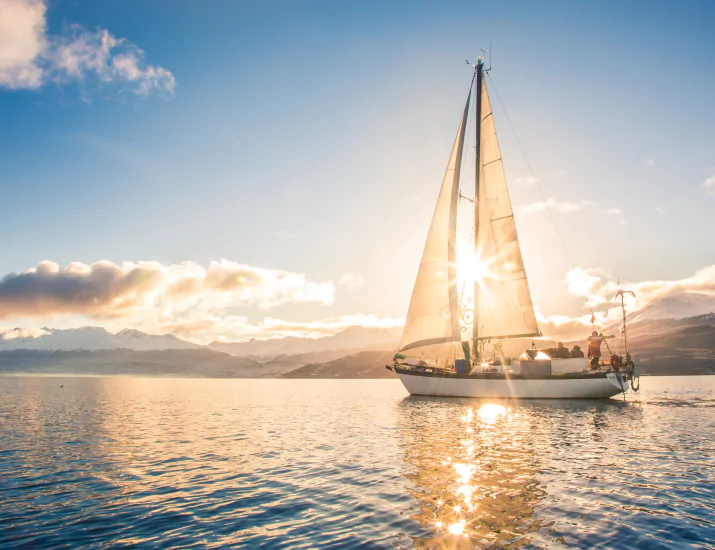 Sailboat in sea on background of mountains